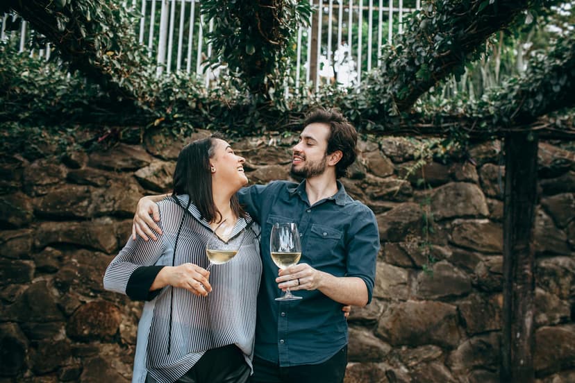 A couple sharing a glass of wine together outdoors on a sunny New Zealand afternoon