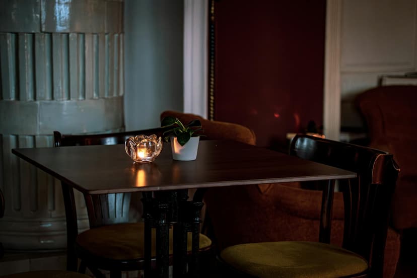 An intimate candlelit restaurant interior set for a quiet evening dinner