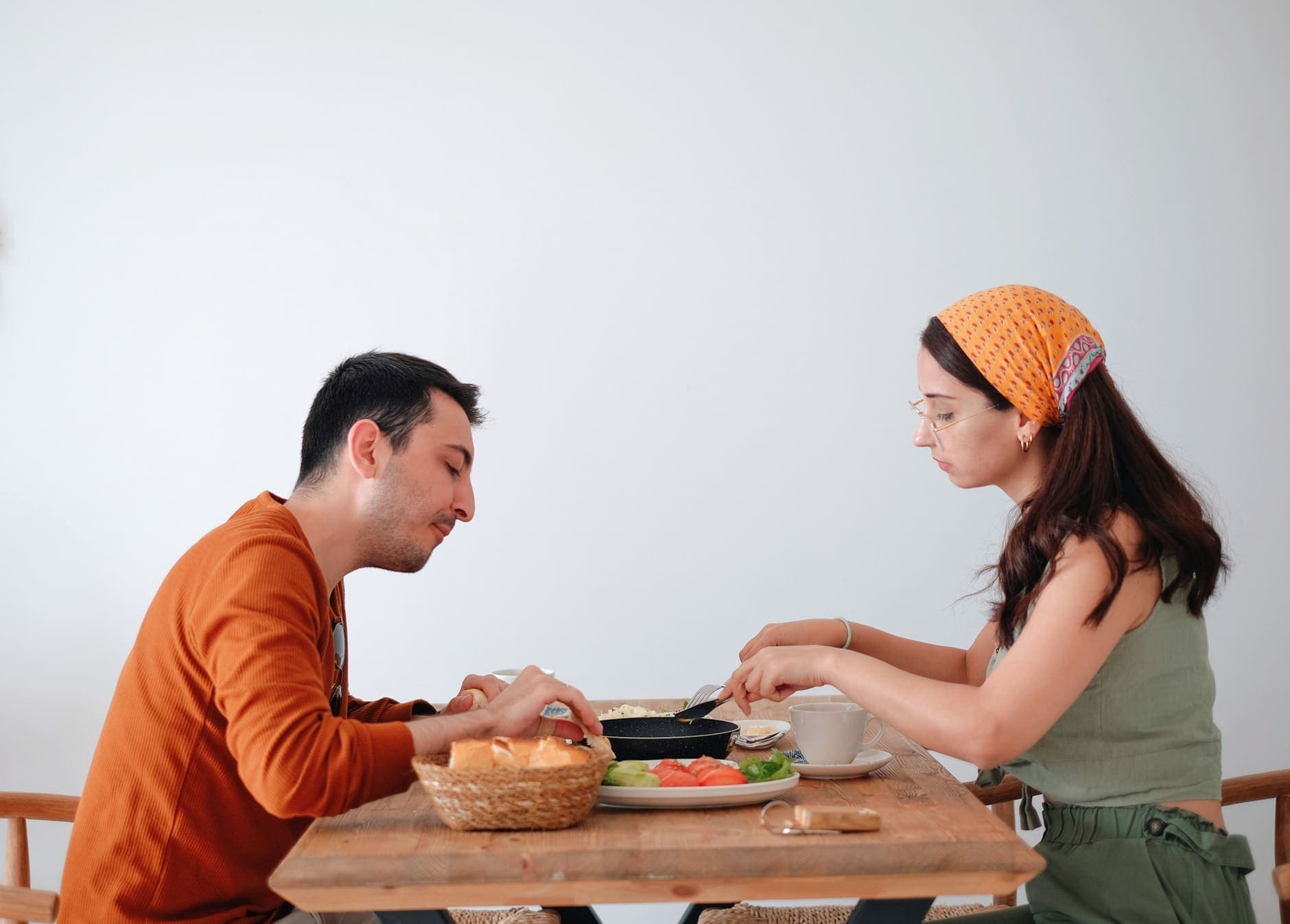 A man and woman enjoy breakfast together at home, adding warmth to their morning routine.